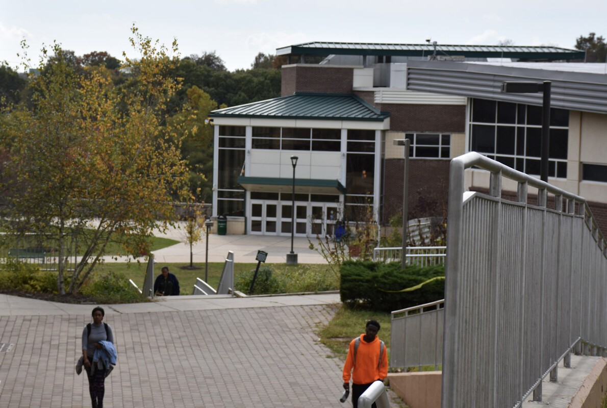 view of students walking with west building in distance