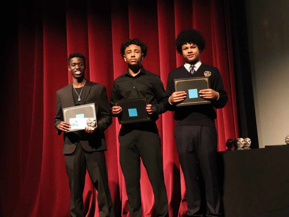 three male students holding certificates