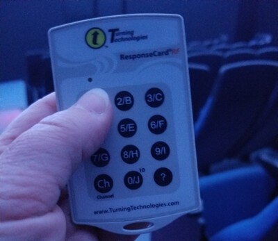 hand on clicker for business class