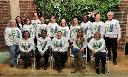 staff pic on Giving Day 2024 in front of green wall
