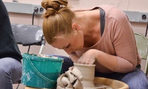 Ceramics student on pottery wheel