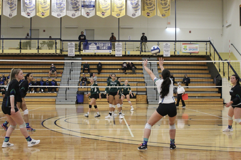 back of girl playing volleyball during team game