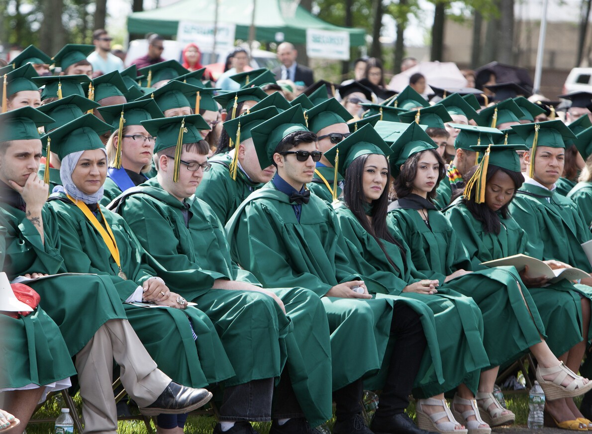 grads in green robes at commencement