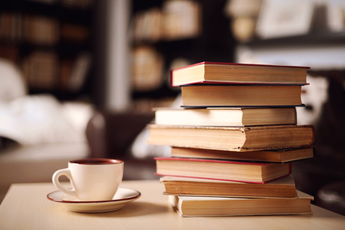 cup of coffee and stack of books
