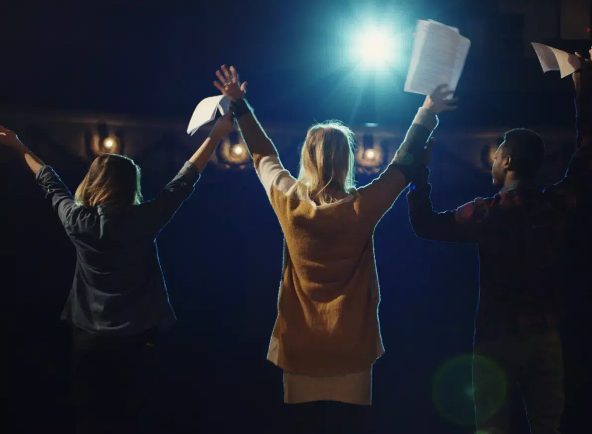 back of 3 actors about to bow