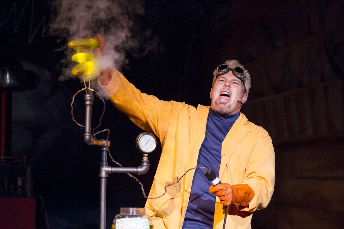 man in yellow jacket doing science experiment