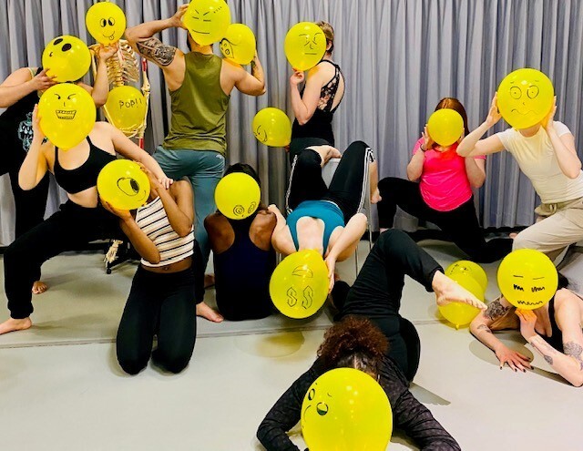 dancers with yellow face balloons