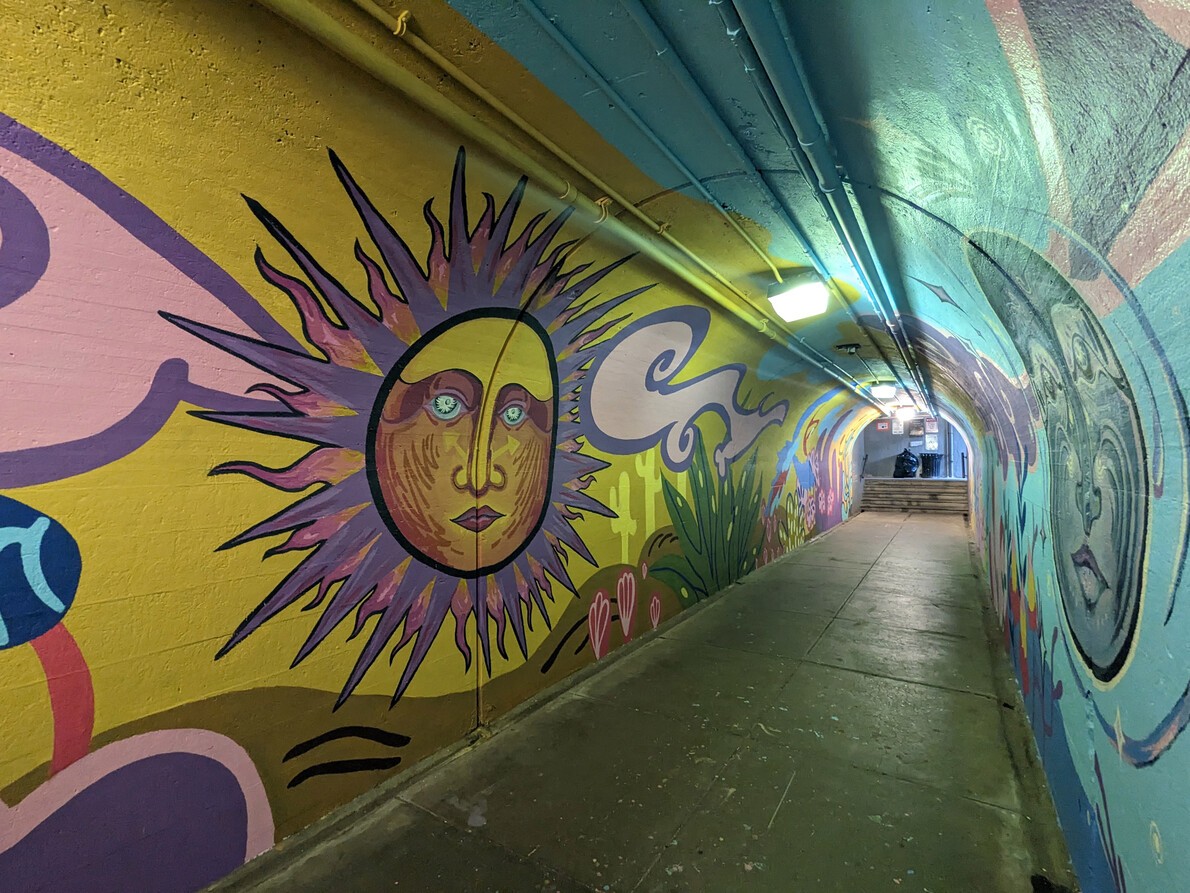 tunnel mural with giant sun