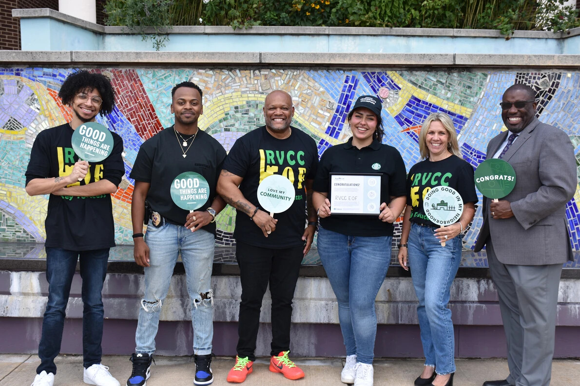 eof staff and jason in front of tile mural