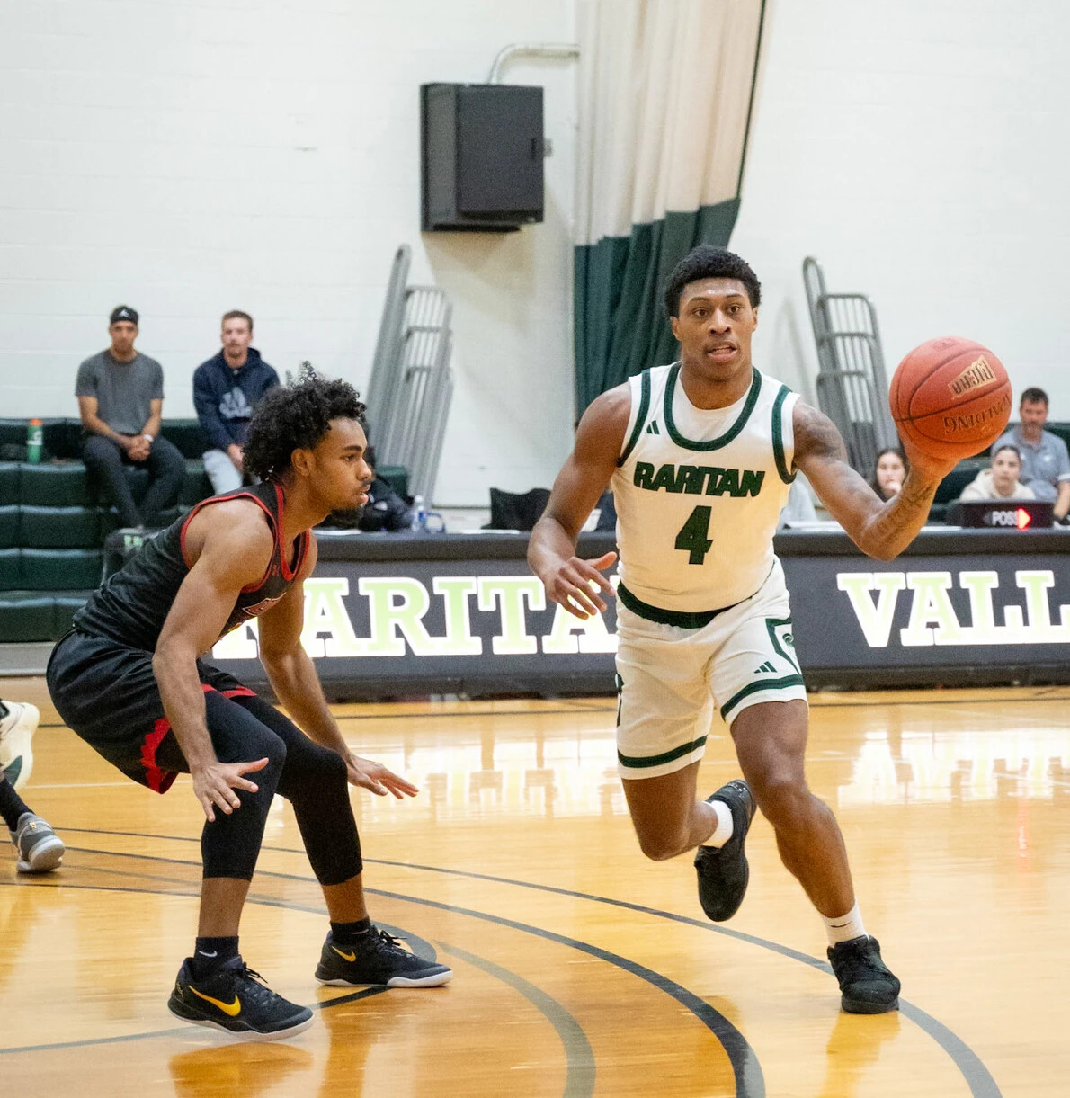 men's basketball player with ball in game
