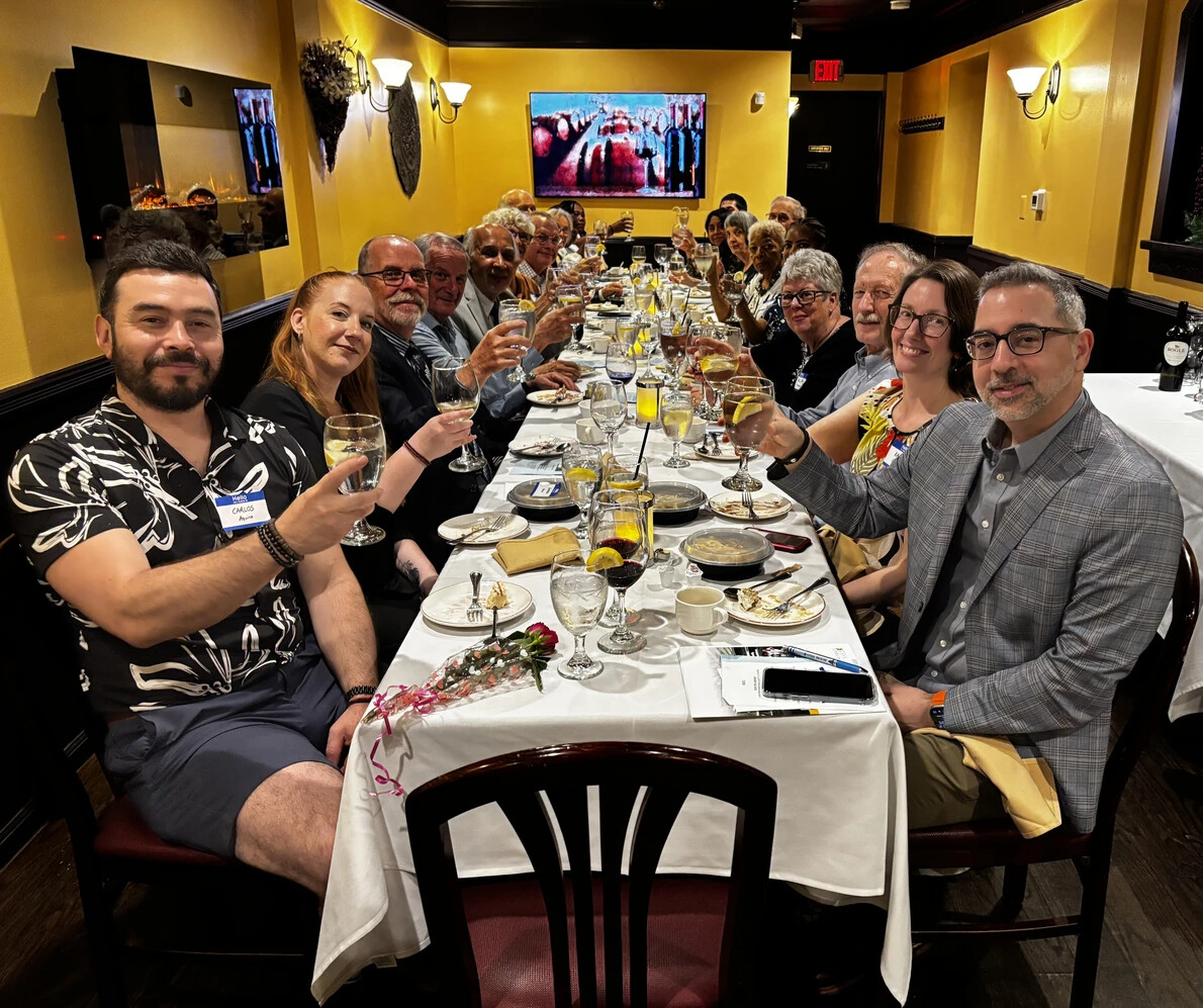 js henderson scholarship fund trustees toasting a long table