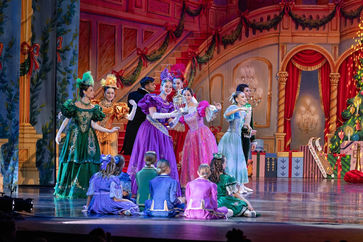 dancers standing and sitting on stage in nutcracker