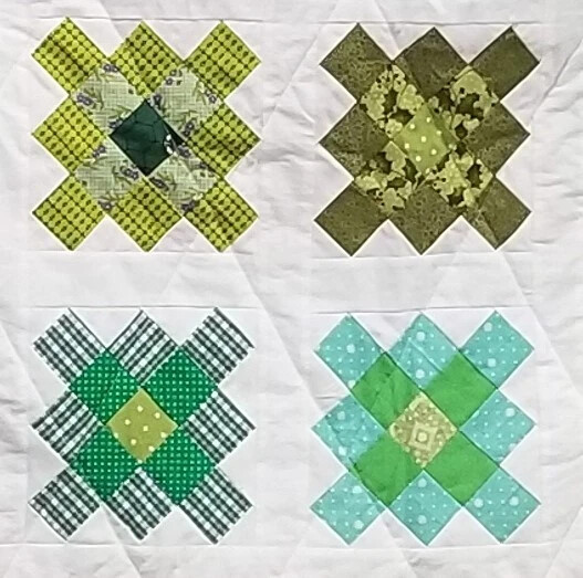 quilt with squares in green patterns