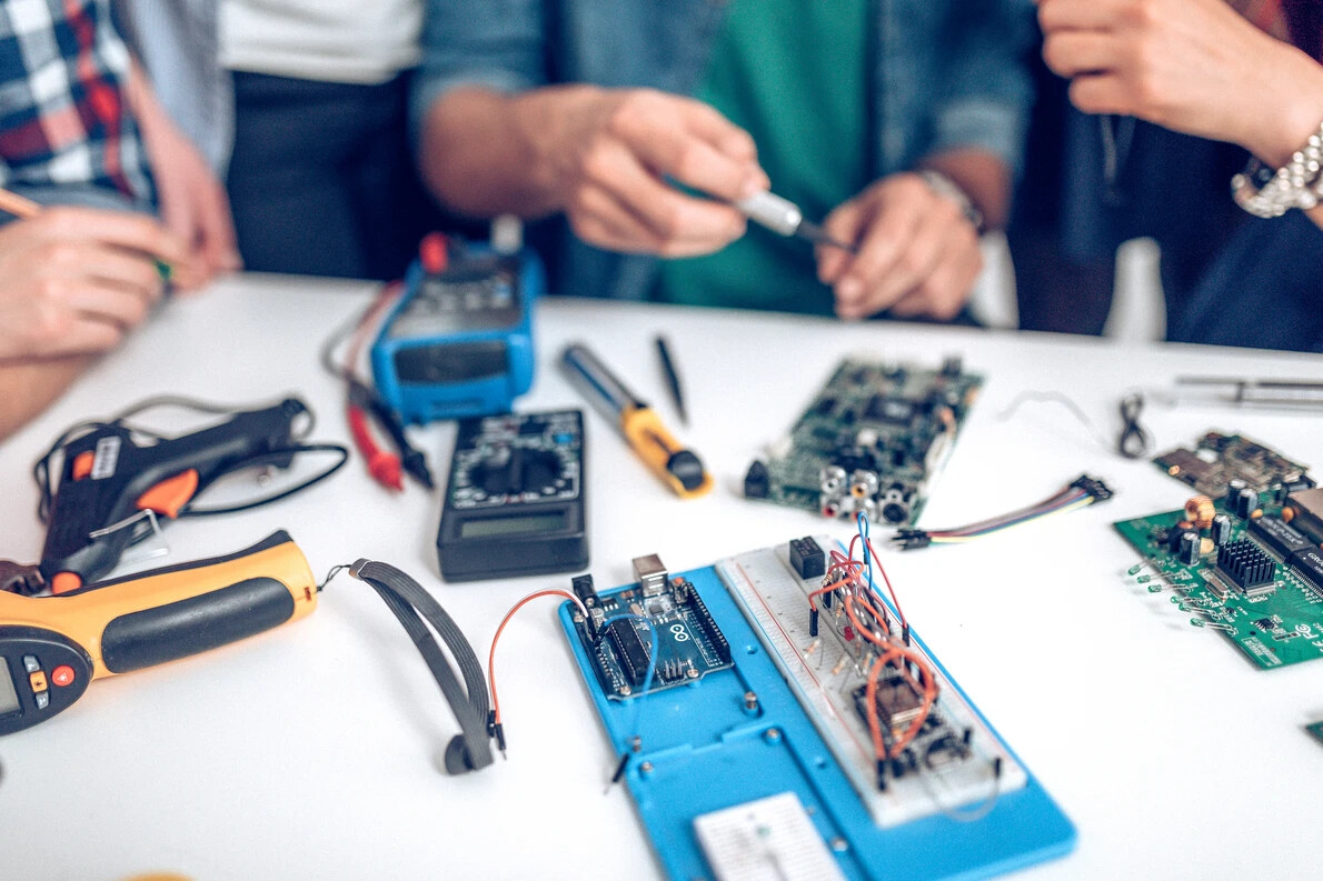 hands working on circuits