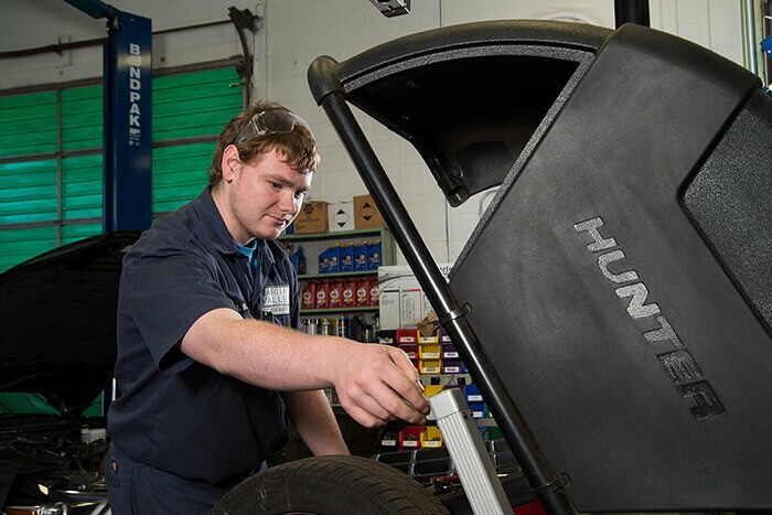 young man working on car