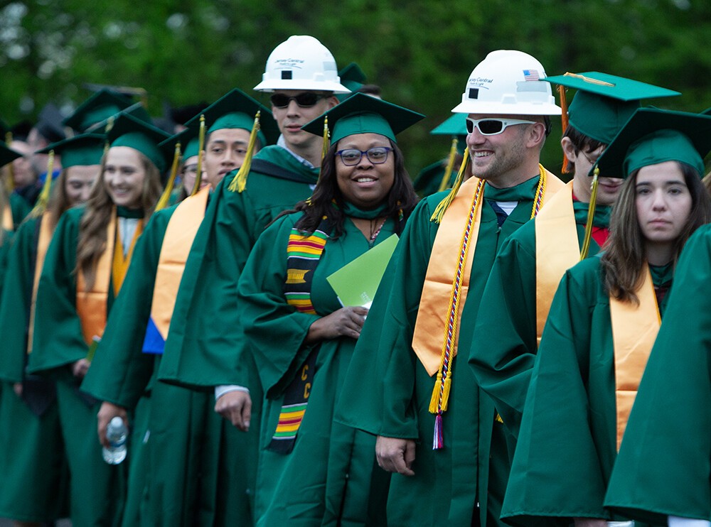 lines of grads, two males wearing hard hats