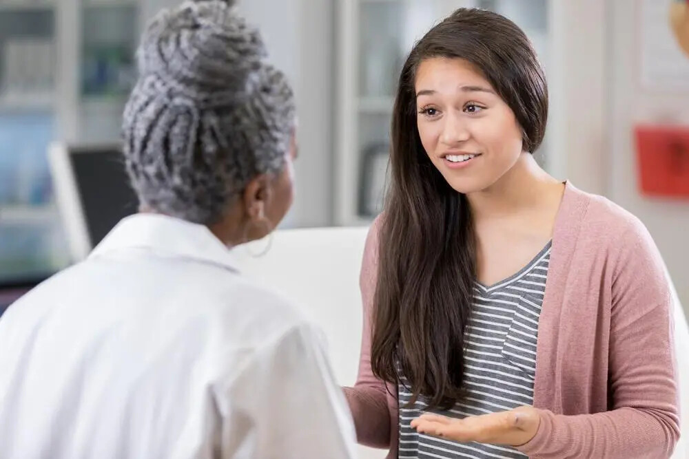 female doctor and female teen