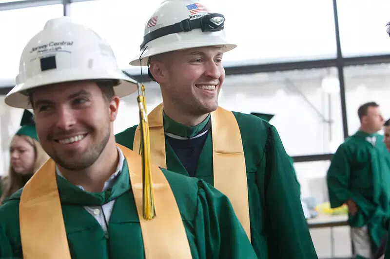 2 male grads wearing hard hats
