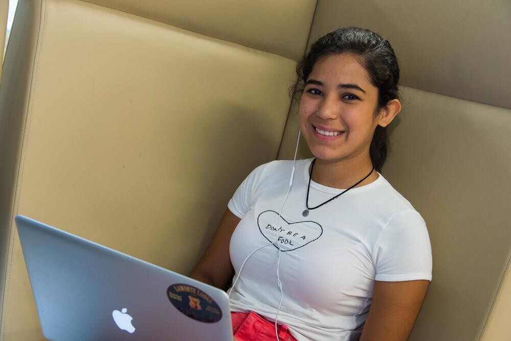 girl in white t shirt and laptop