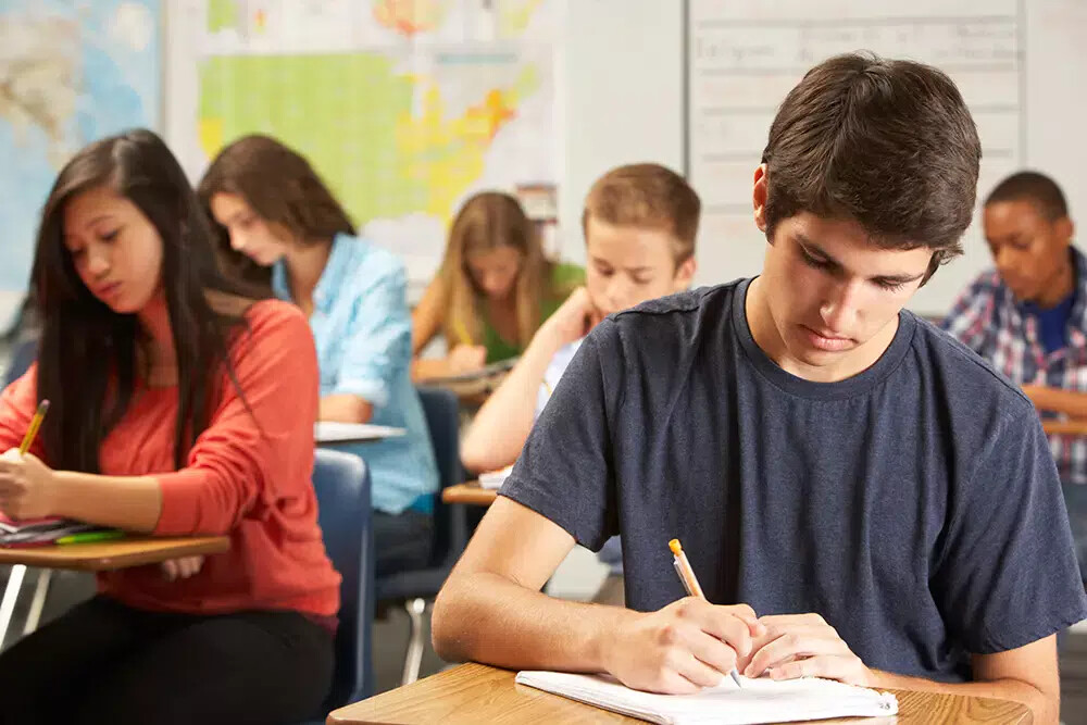 class of students taking a test