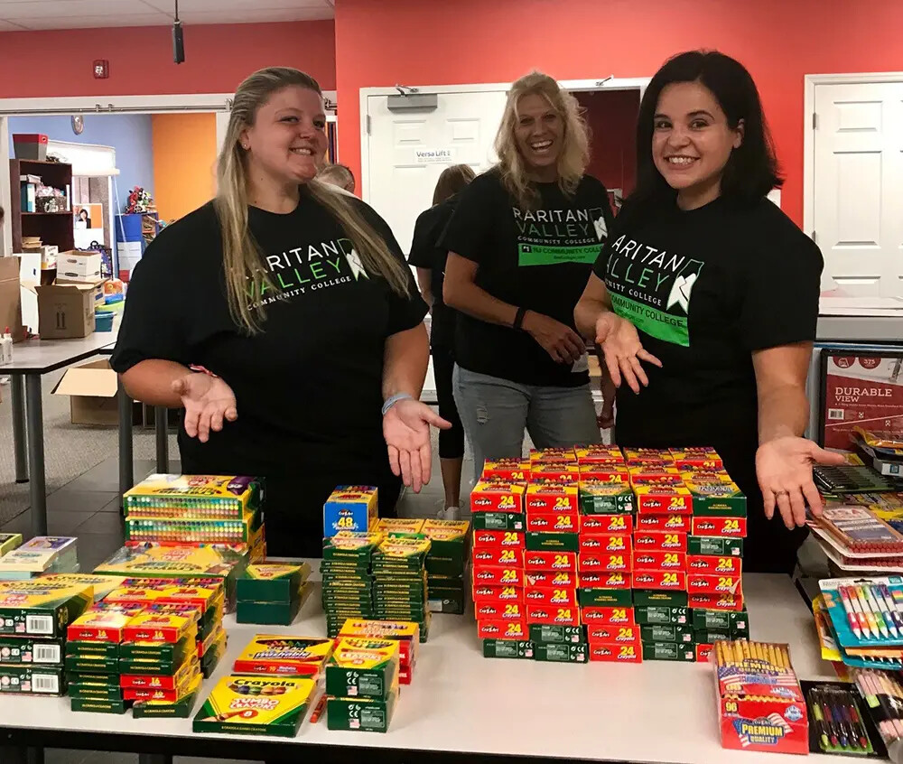 3 female ota students sorting school supplies
