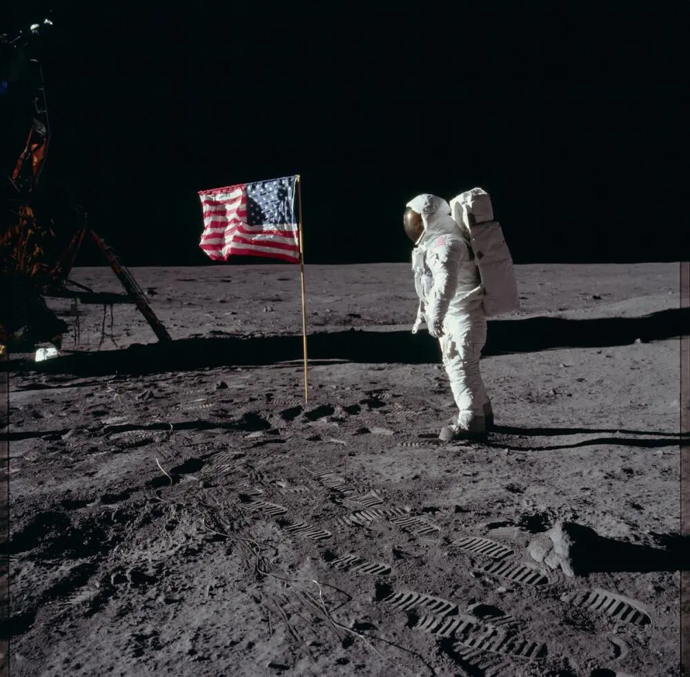 astronaut on moon with american flag