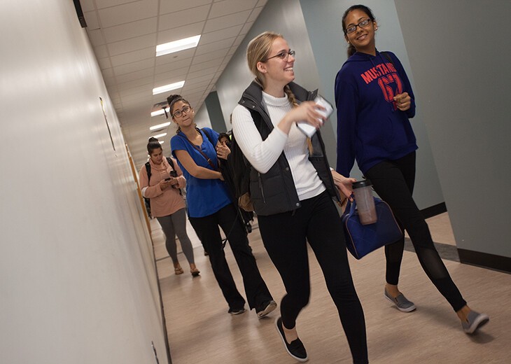 angular view of female students walking in hallway