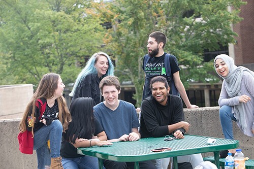 group of students around table outside