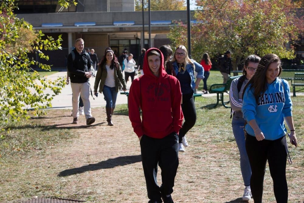 group of students in sweatshirts walking outside