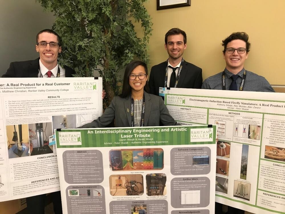 engineering students with posters at national conference