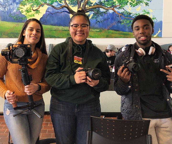 3 students with cameras and microphones