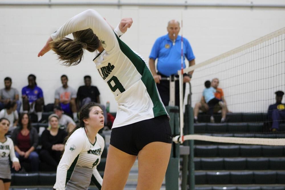 female volleyball player jumping in air