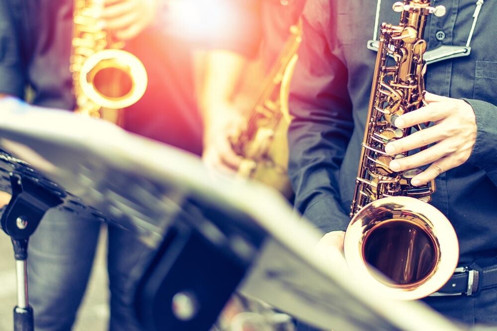 blurred images of hands on saxophones