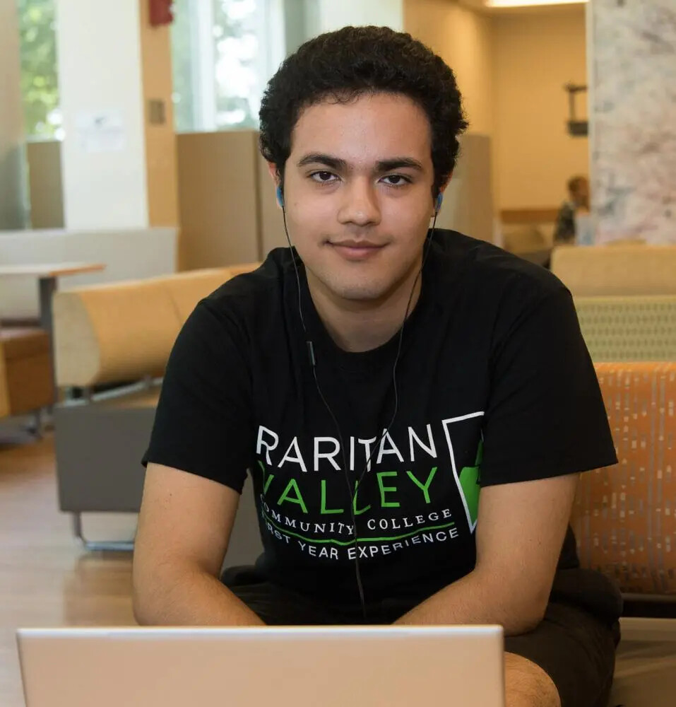 student at laptop cropped at bottom