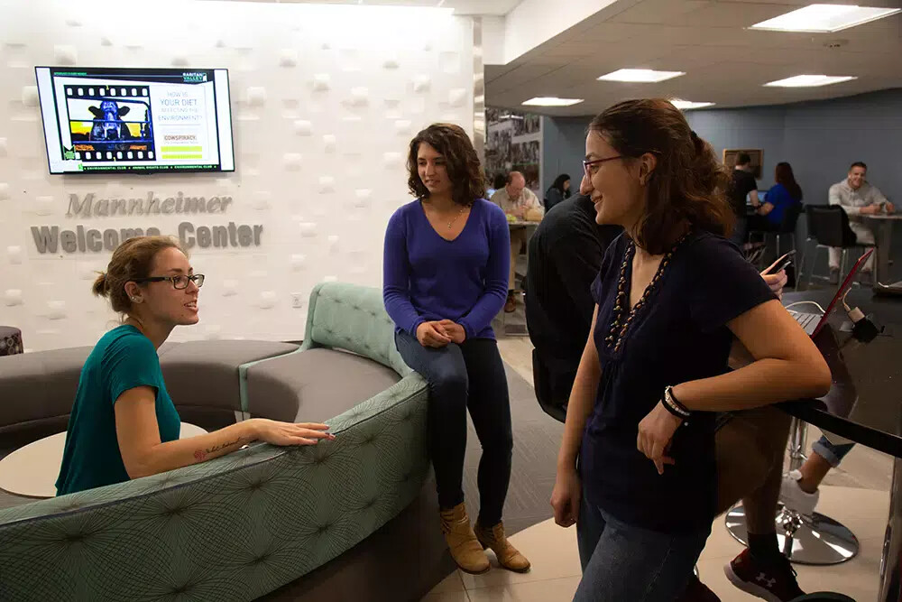 3 female students at welcome center