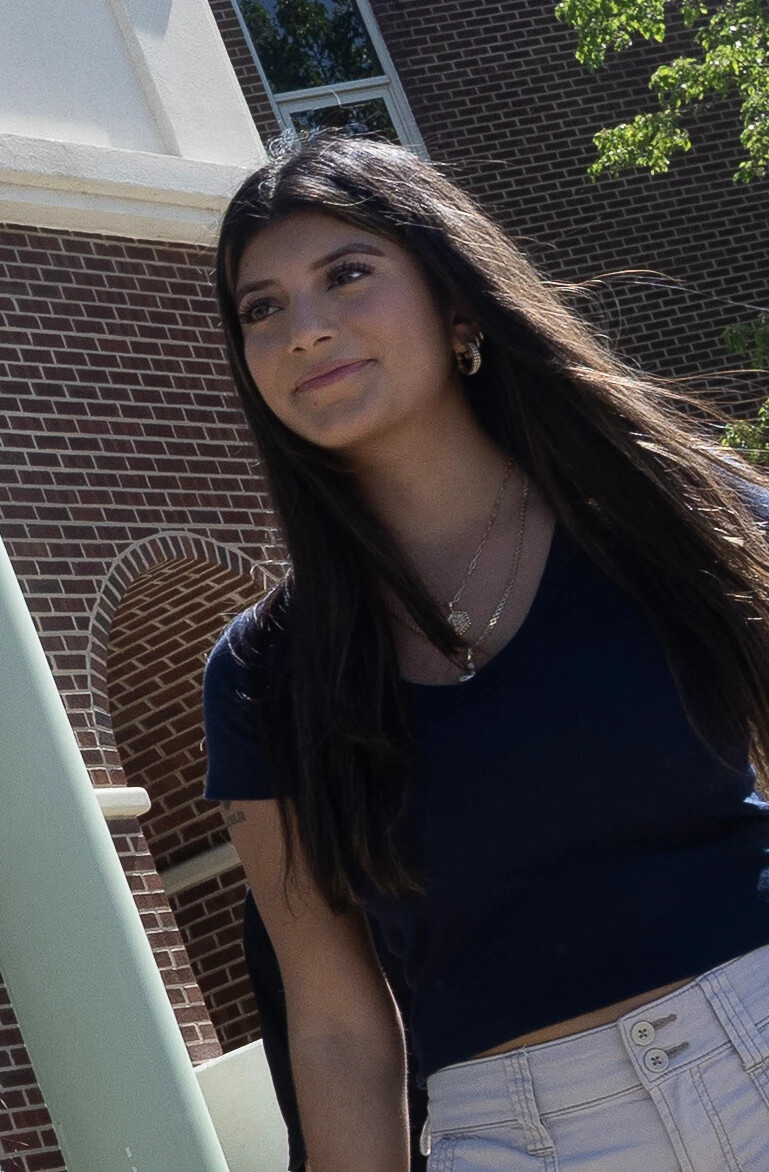 student walking outside the front entrance to RVCC