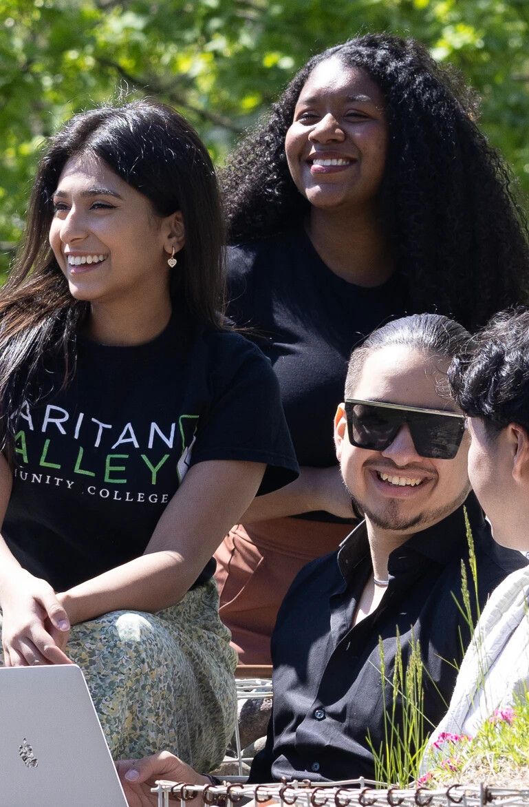 4 students smiling in the sensory garden