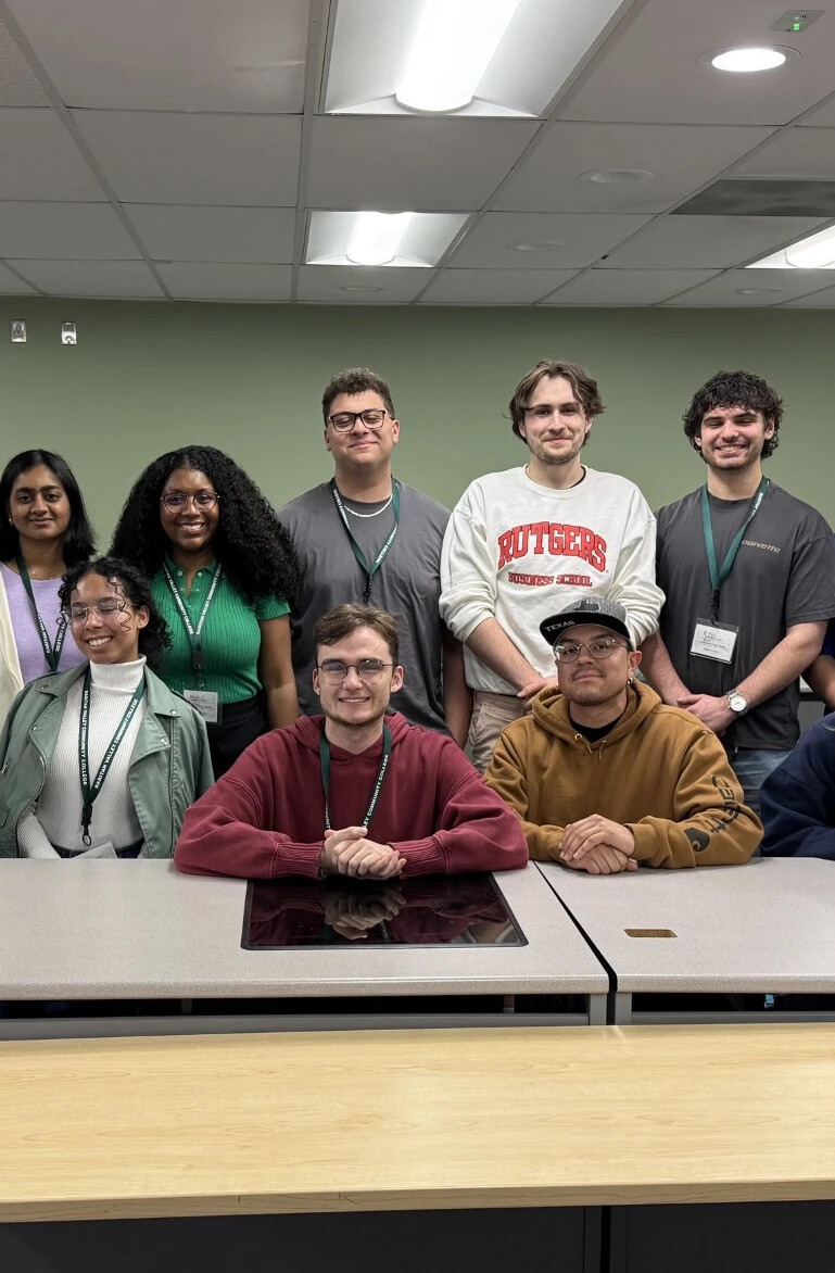 group os students in various color sweatshirts posing for a photo