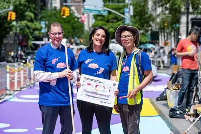 3people standing on street mural