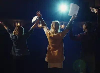 back of 3 actors about to bow