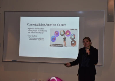 female student in suit with powerpoint presentation