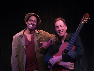 finding north picture with two men and one holding guitar