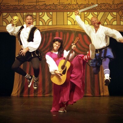 three performers with 2 jumping in air