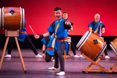 male taiko drummer and other drummers