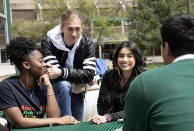 students outside sitting at table