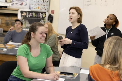 students standing and sitting in classroom