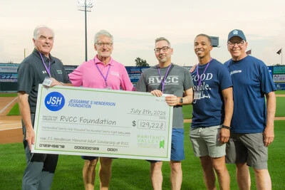 five men holding large check