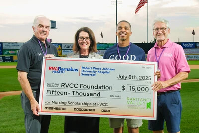 2 men and 1 woman holding large check outside