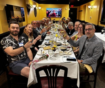js henderson scholarship fund trustees toasting a long table