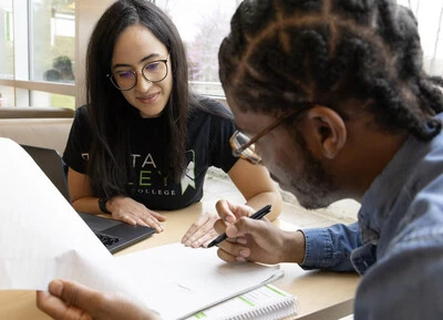 2 students looking at page of paper